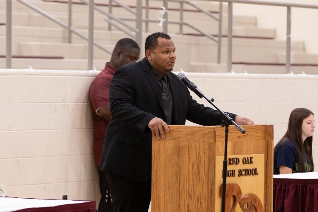 man speaking at podium