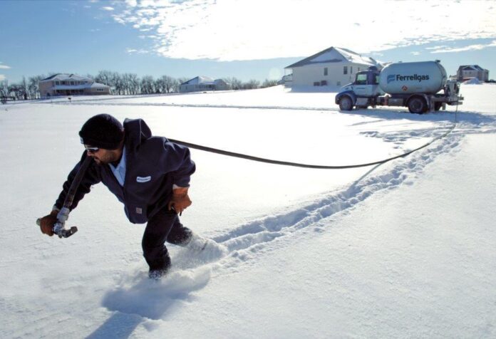 guy in snow with propane truck