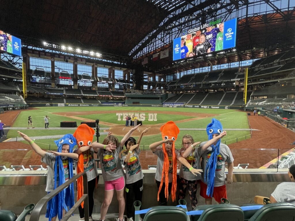 kids at baseball stadium wearing silly hats