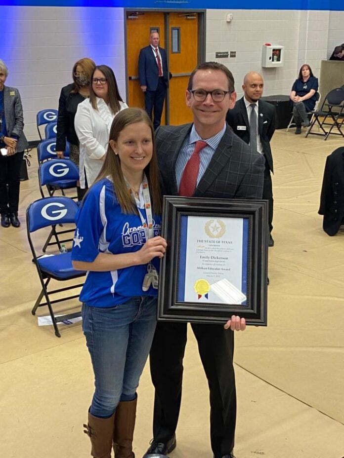Dickerson with Mike Morath Grand Prairie teacher holding award with man