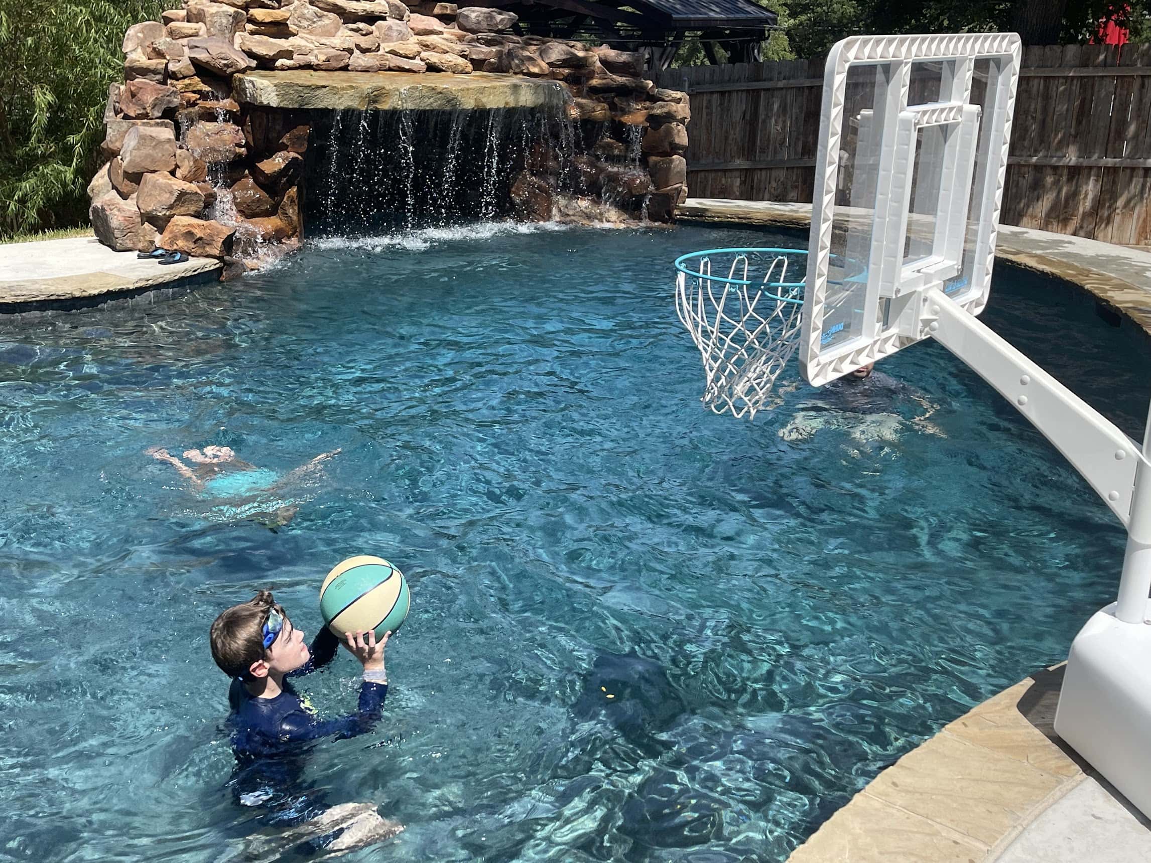 boy playing pool basketball