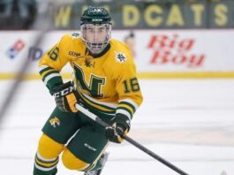 hockey player hitting puck