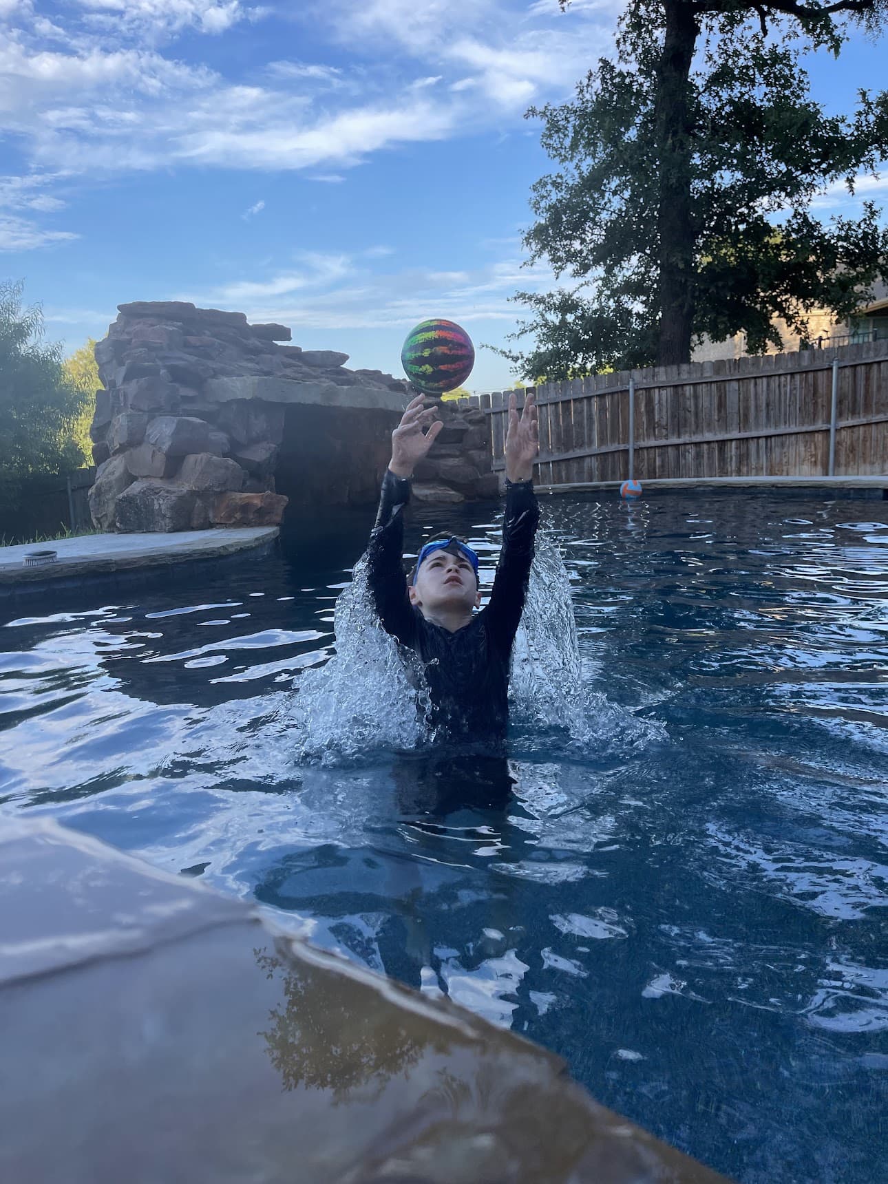 boy playing with ball in pool