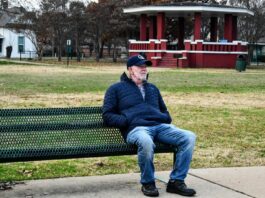 man sitting on park bench