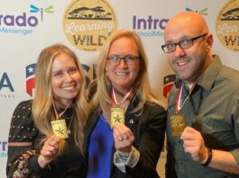 Two ladies and man with medals