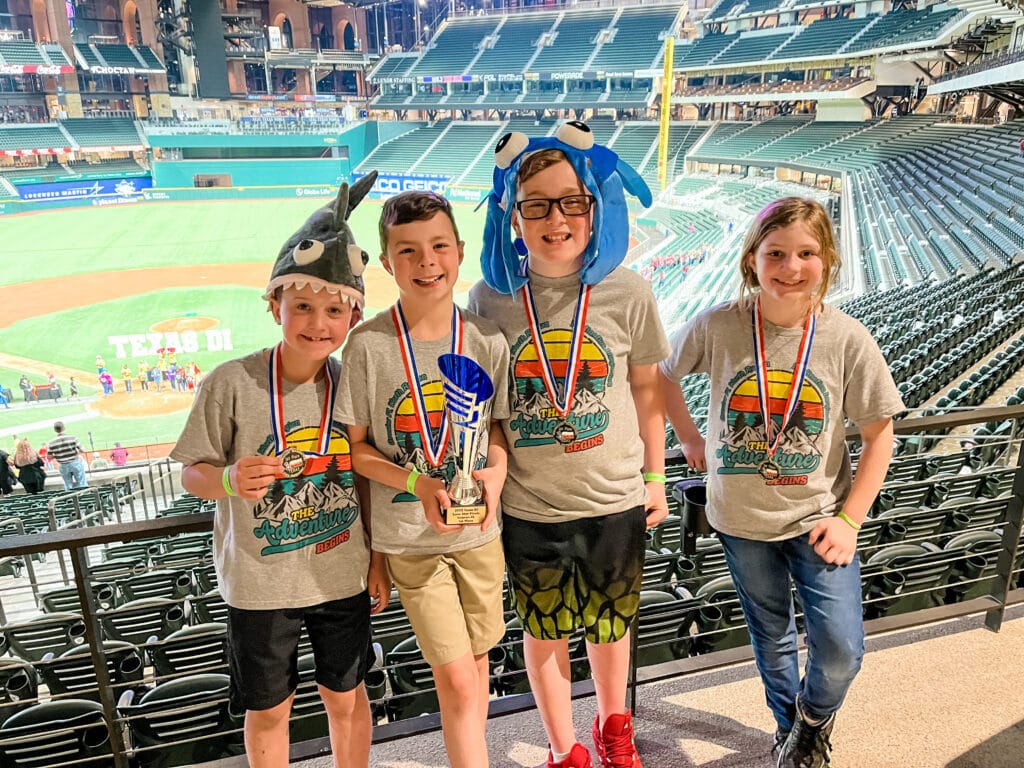 four kids with stadium in background