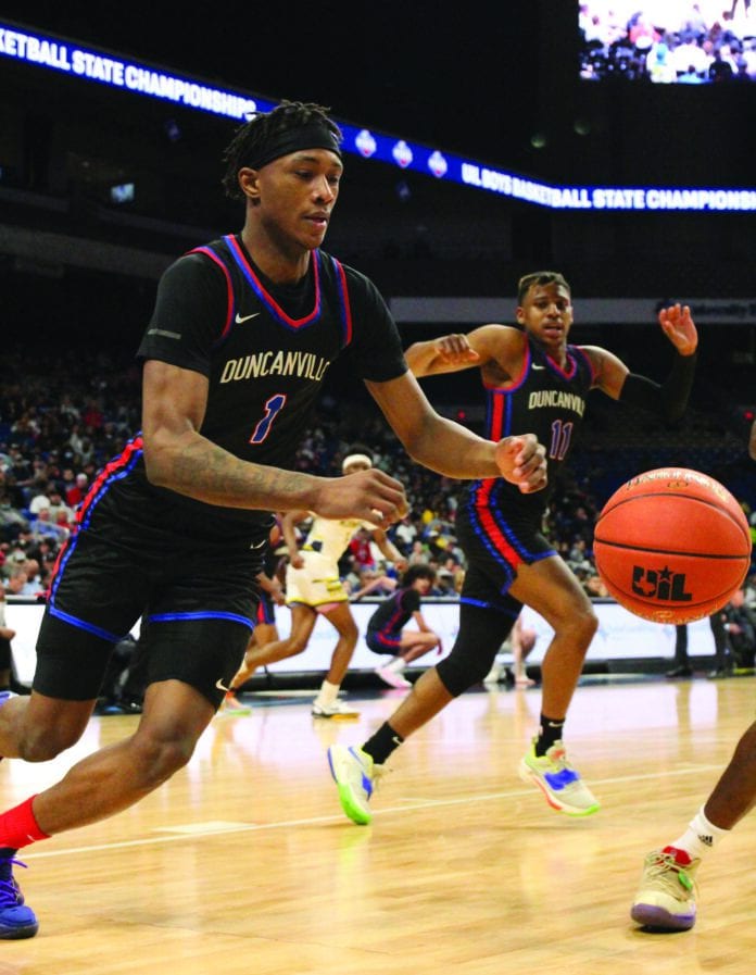 Ronald Holland drives toward goal while Aric Demings guards his drive (1) Duncanville basketball player driving ball
