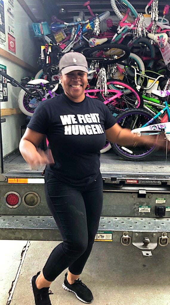 Lady in front of truck with bikes