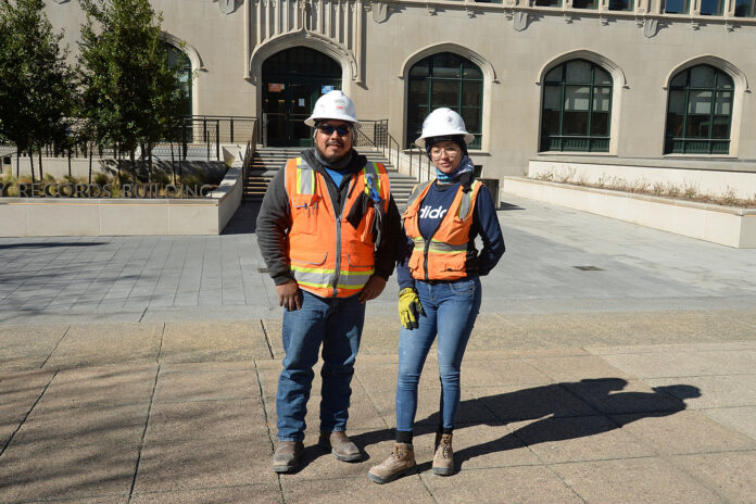 dbiLT006x man and woman in hard hat and orange vest