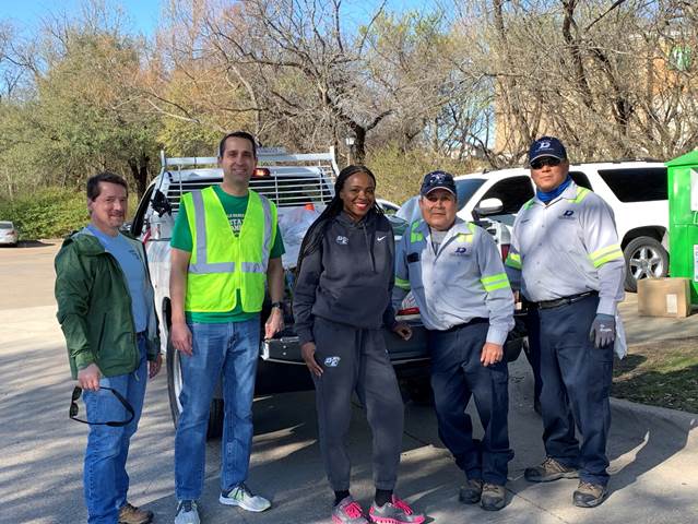 adults standing by a truck