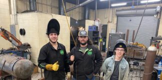 Red Oak Seniors Molding Their Futures Through Welding three guys wearing welding helmets