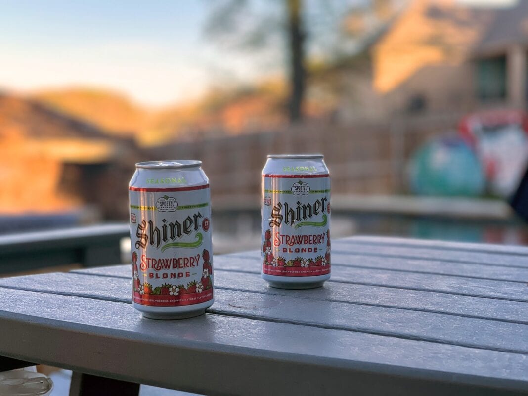 Shiner strawberry cans on table outside