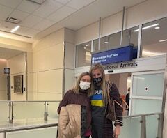 two ladies at airport wearing masks