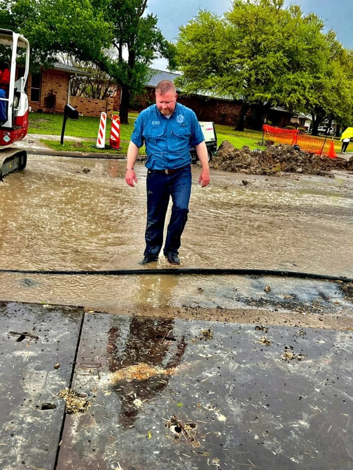 Brooks Williams working on water repair