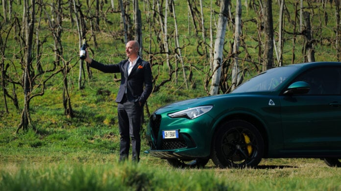 man in front of Alfa Romeo SUV