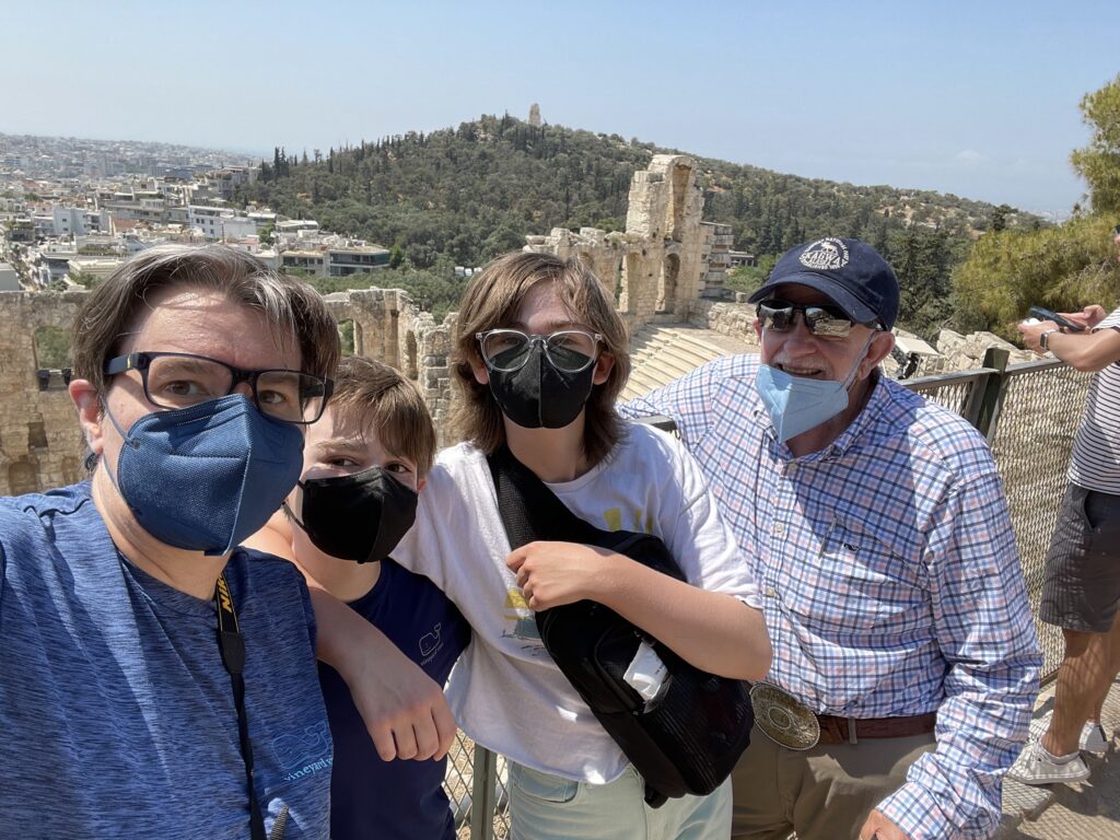 family of four wearing face masks