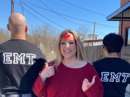 Girl standing next to EMTs