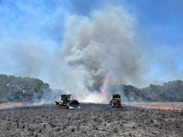 construction equipment battling wildfire