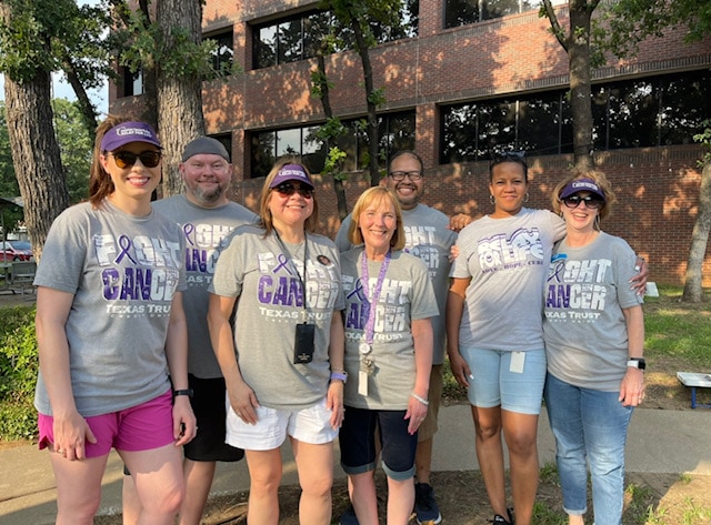 The Texas Trust Community Unity Team helped organize the Relay for Life Walk for the Texas Trust Gives Foundation group of people wearing Relay for Life tshirts
