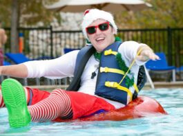 Guy wearing Santa hat on raft