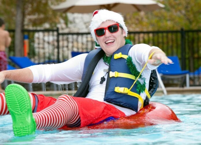 Guy wearing Santa hat on raft