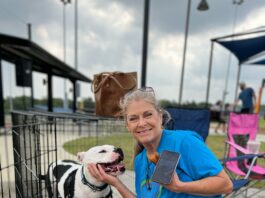 lady with dog in crate