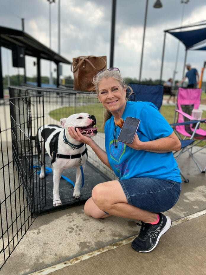 lady with dog in crate