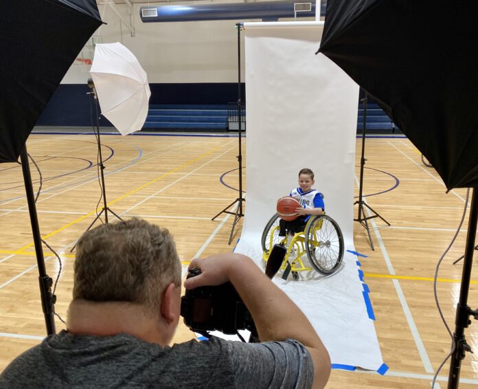 kid in wheelchair being photographed