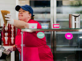 lady handing waffle cone to customer
