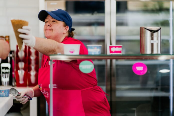 lady handing waffle cone to customer