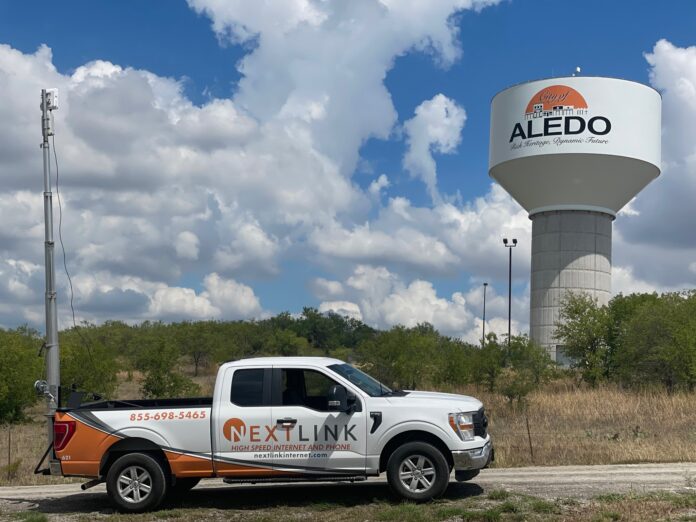 Nextlink truck in front of tower