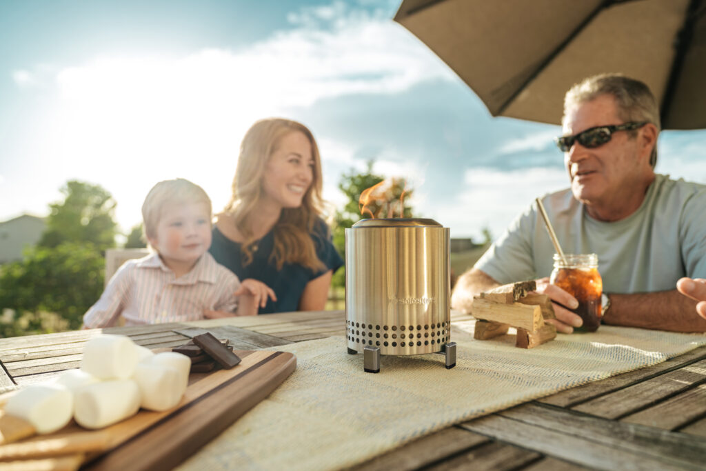 Mesa firepit on table with famil around it