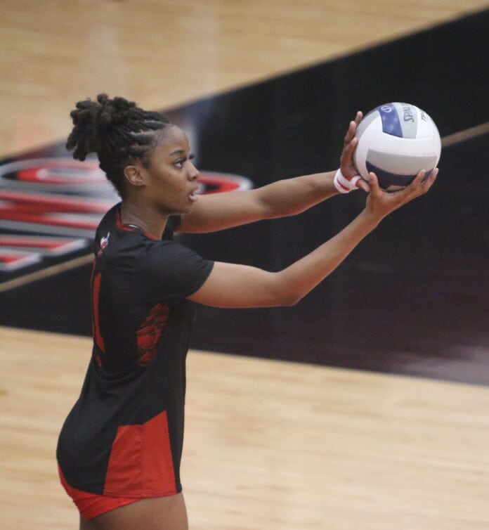 Jamia Johnson serving volleyball