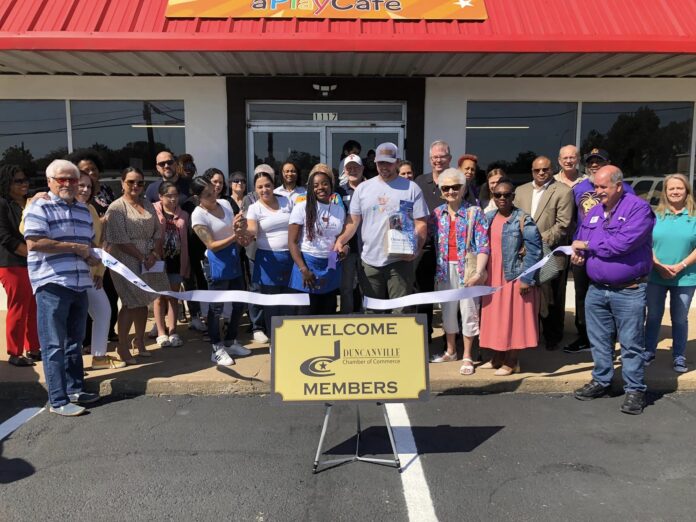 A Play Cafe ribbon cutting with chamber