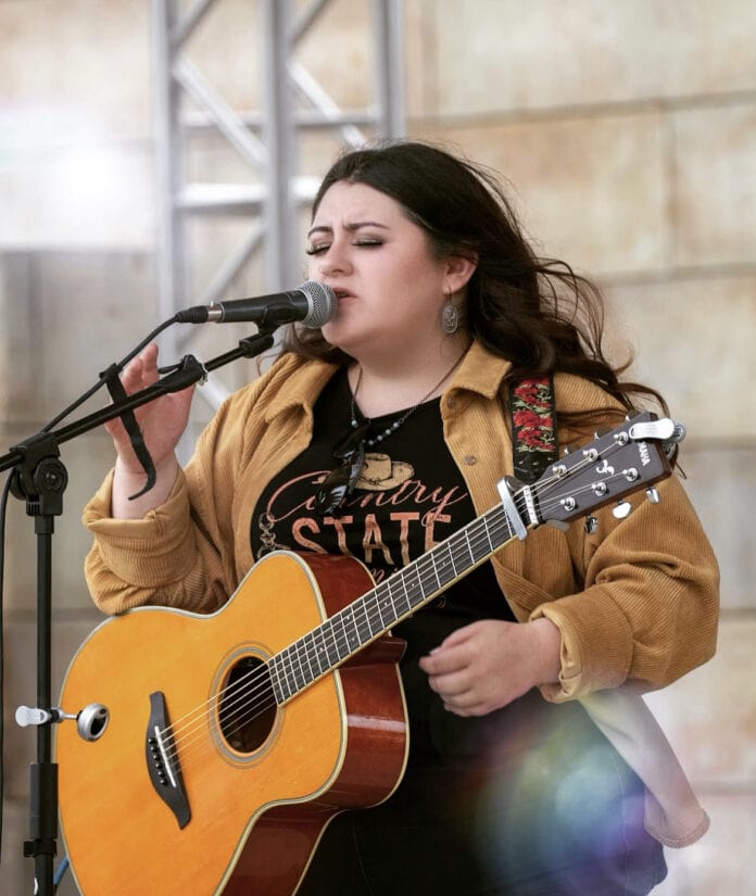 Jade Flores singing with guitar