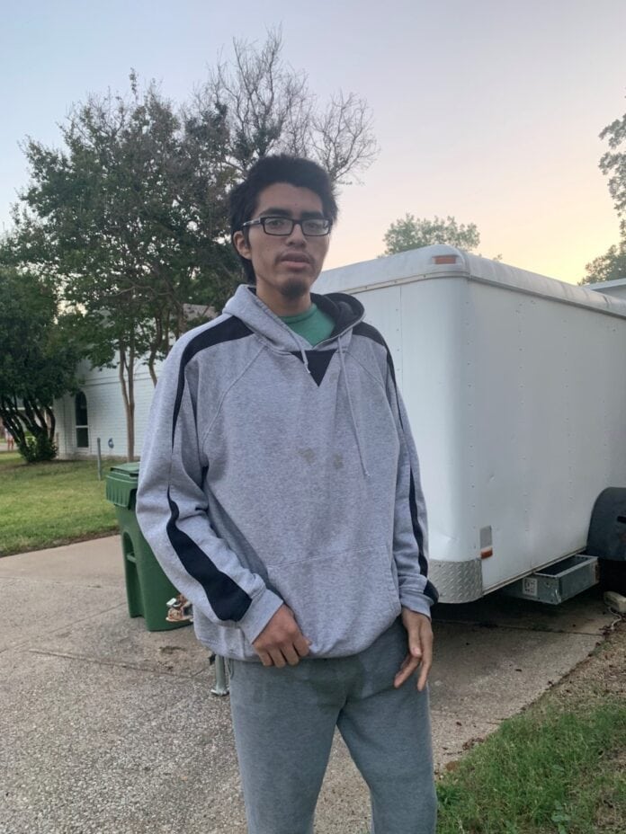 hispanic male in front of trailer