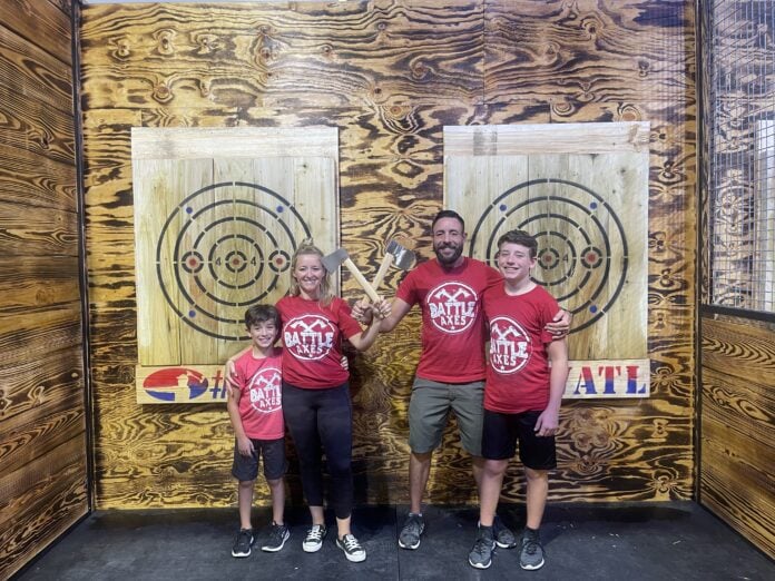 family in front of axe targets