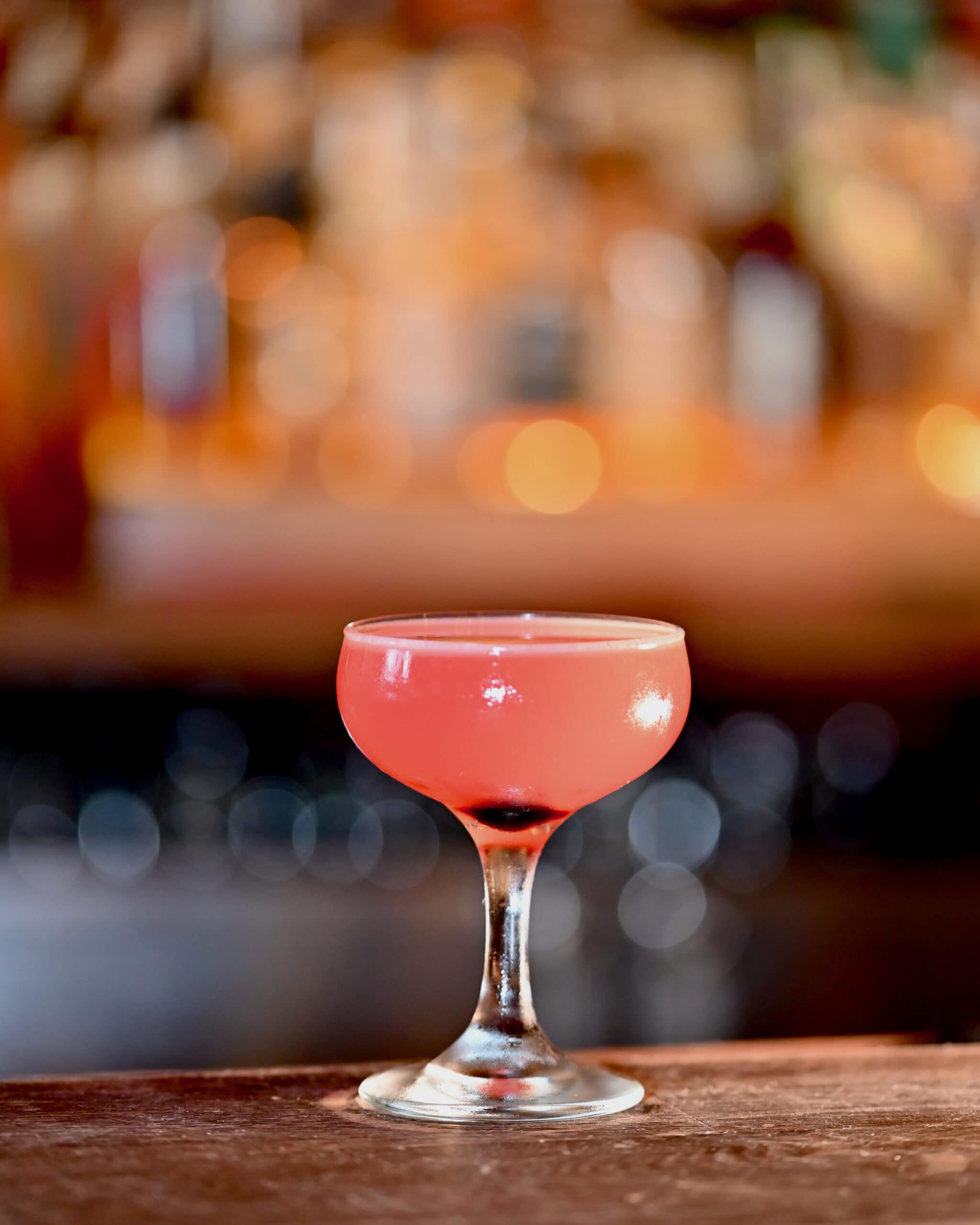 pink drink in cocktail glass