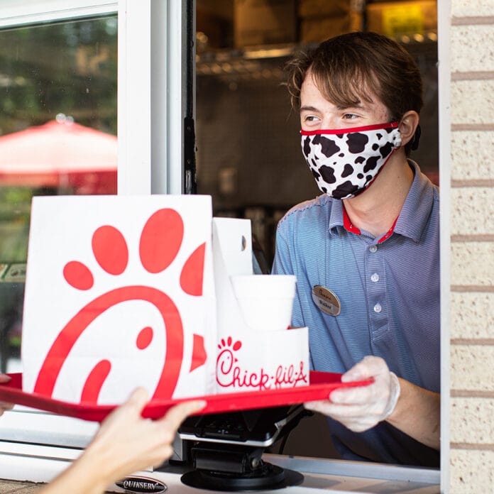 Chick fil A employee handing food