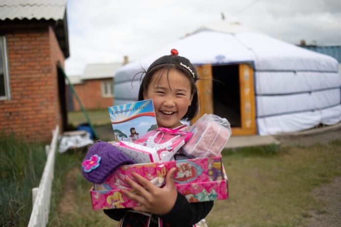 child holding presents