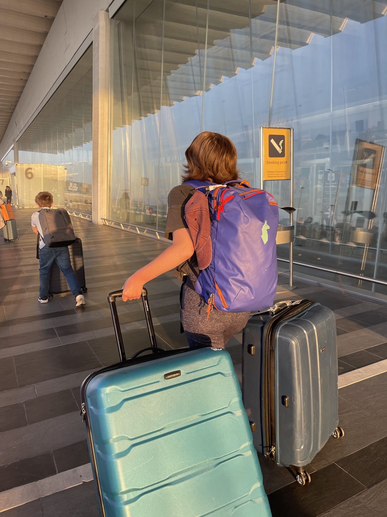 girl with Cotopaxi bag and suitcases