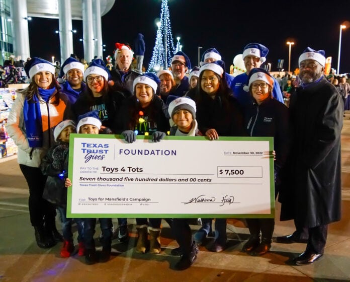 Texas Trust employees with big check