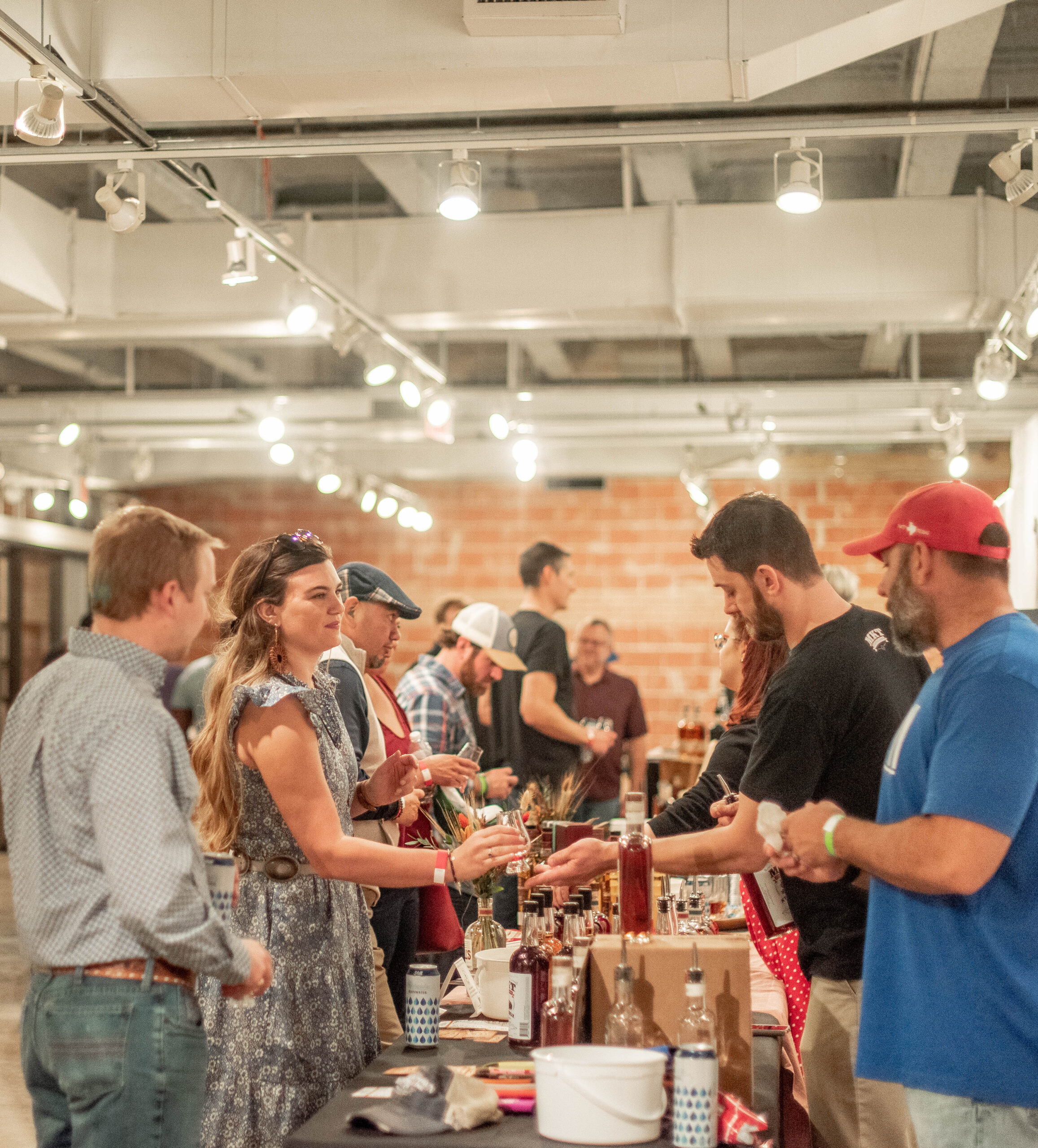 line of adults by whiskey bottles