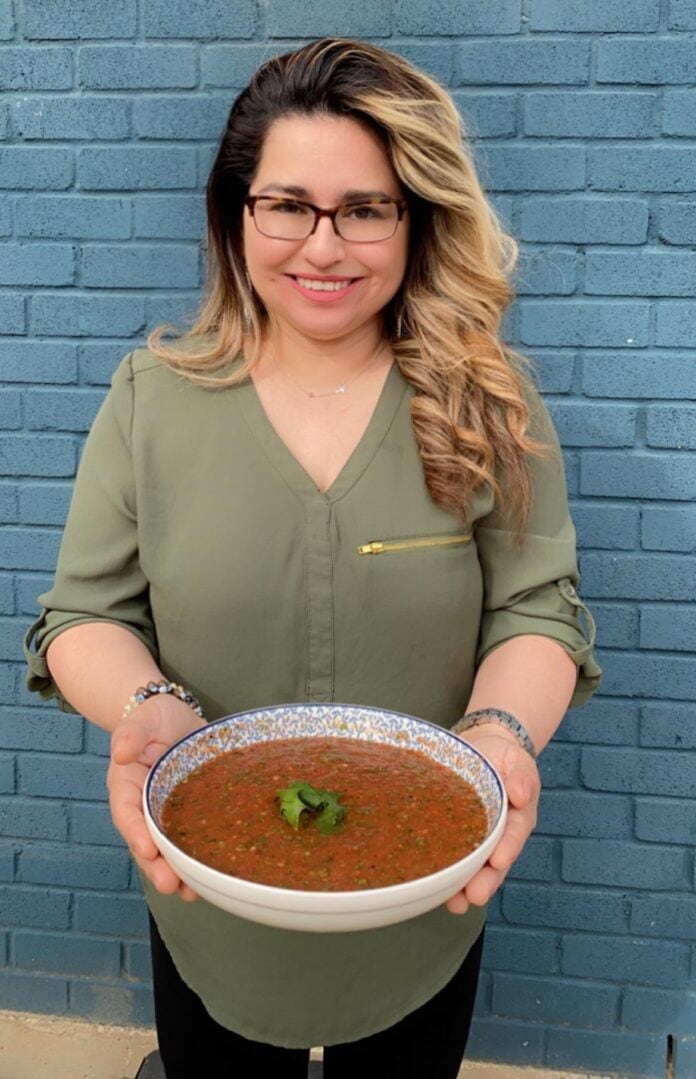 lady holding bowl of salsa