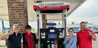 Cedar Hill ISD Education Foundation (CHEF) Partners With Fuel City adults standing beside fuel pump