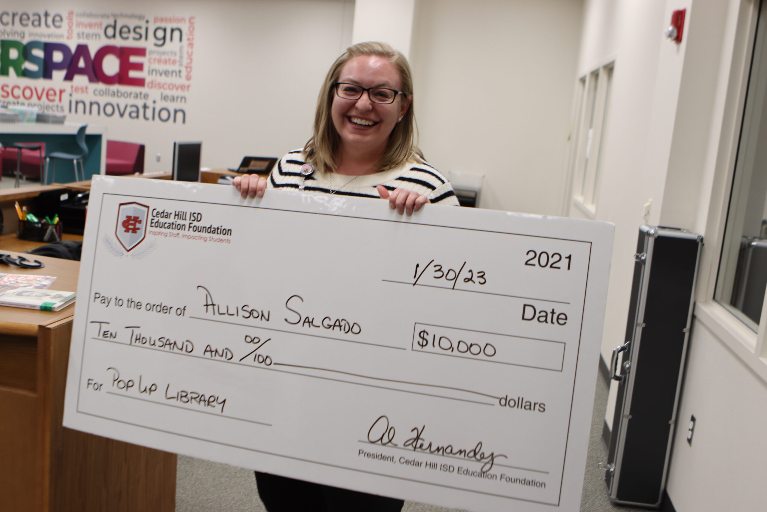 Allison Salgado holding cardboard check