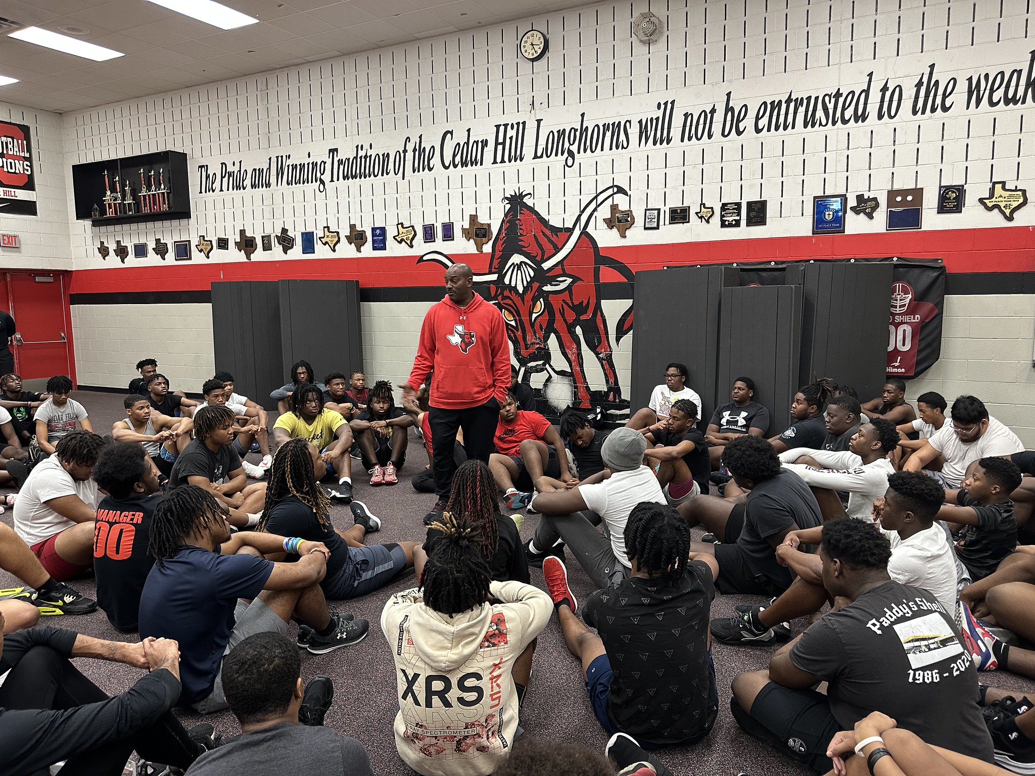 man talking to group of student athletes