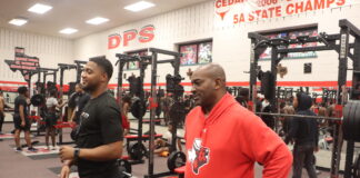 Cedar Hill’s New Football Coach Plans To Be Involved In Community two men standing in gym