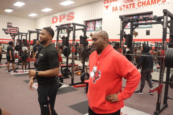 two men standing in gym