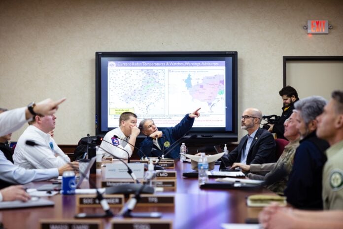 Governor Abbott in front of storm map